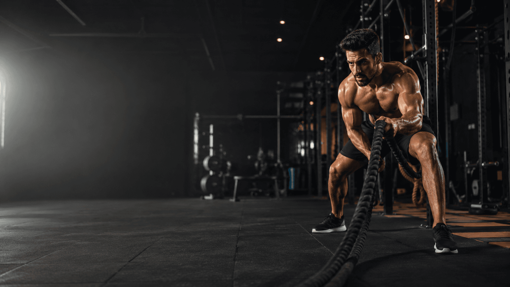 Athlete training with battle ropes at Phoenix Fitness